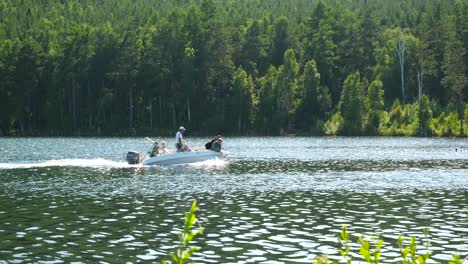 people on a motorboat on a lake