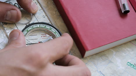 hiker setting compass from a map