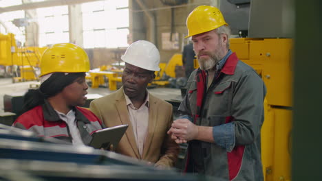 Group of Quality Control Inspectors Working in Factory