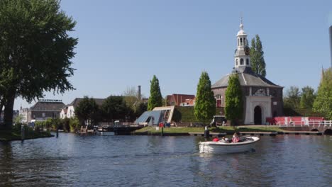 maritime traffic in a city in the netherlands on a sunny day, featuring historical gate
