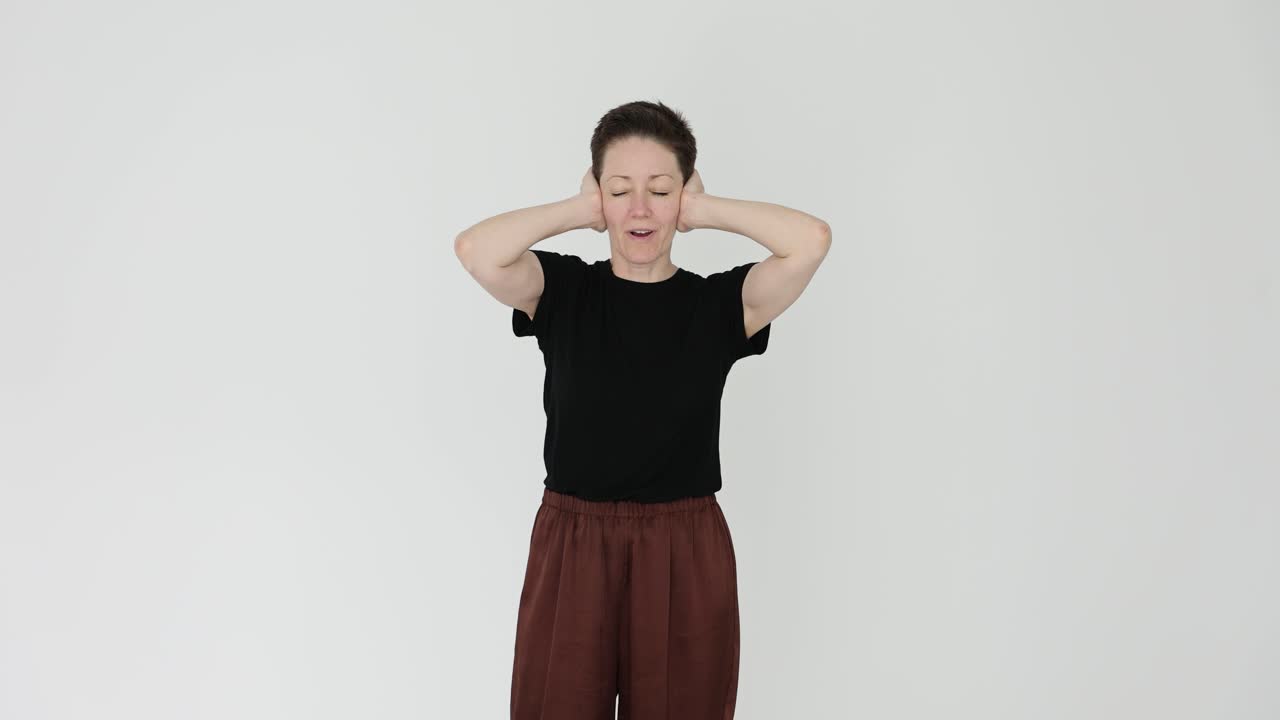 Woman covering ears due to loud noise