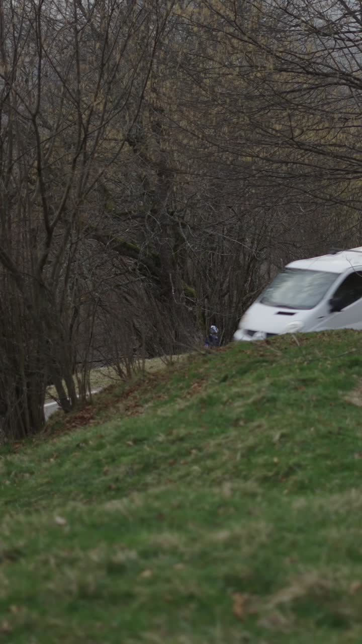 A grassy hill with a person in the background