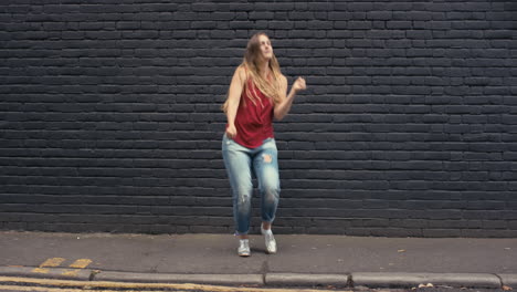 Contemporary-funky-caucasian-woman-street-dancer-dancing-freestyle-in-the-city