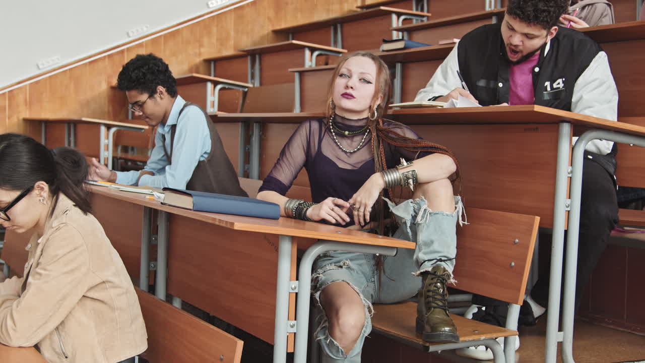Gothic Female Student in Ripped Jeans in Classroom