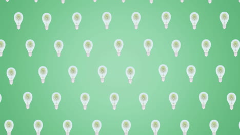 animation of multiple falling light bulbs with trees inside on green background