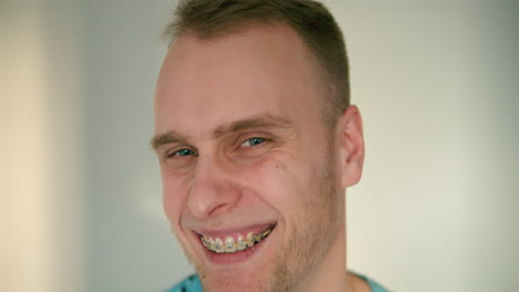 close up of man's face smiling heavily in slow motion