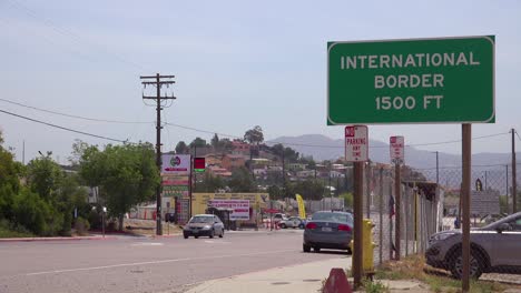 a sign announces the international border between the us and mexico