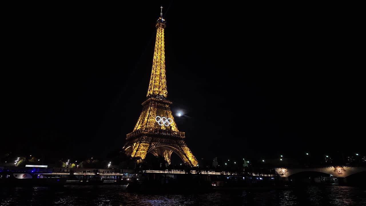 Eiffel tower Olympic rings at night Paris France light up, tourist landmark