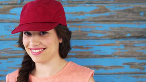 fashionable woman standing against wooden background