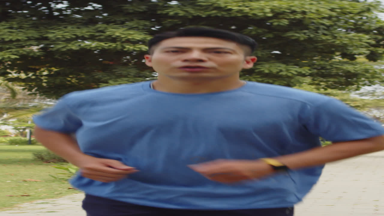 Male Athlete Running in Park Alone