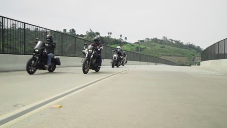 Pack-of-Harley-Riders-Fly-By-on-Street