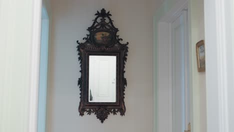 vintage mirror detail in bright hallway interior with white door reflection