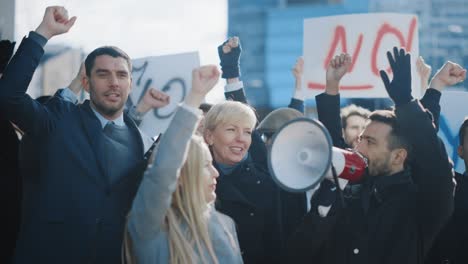 multicultural diverse office managers and business people picketing outside on a street. men and women screaming for justice, holding a megaphone, picket signs and posters. economic crisis strike.