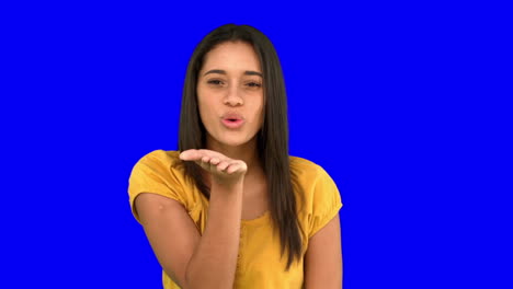 woman blowing a kiss on blue screen