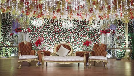 the wedding venue stage, embellished in stunning theme, is delicately decorated with a variety of vivid flowers