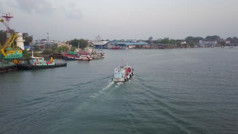 Fishing-Boat-Sailing-Across-The-Sea-And-Passing-By-The-Port-Of-Rayong-In-Thailand