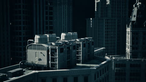 modern cooling systems on the rooftop of a high rise building at dusk
