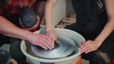 pottery class - two people working on pottery wheel