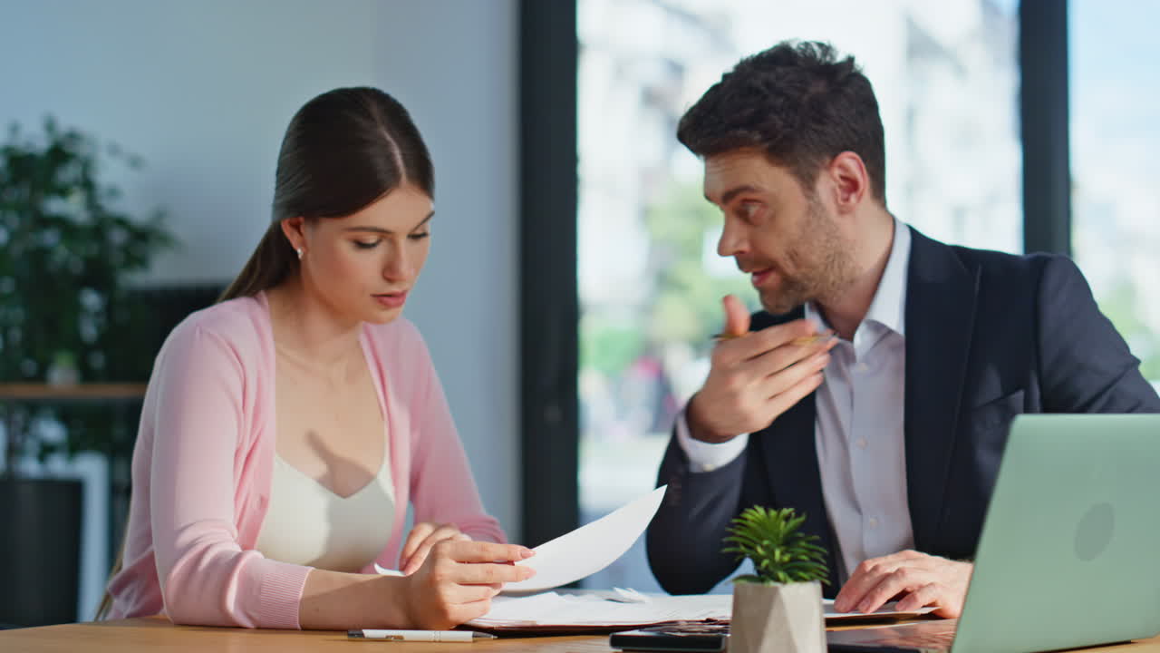 Business manager mentoring woman explaining project details in office closeup