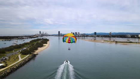 unique aerial view of a extreme recreational water sports with an urban city skyline background