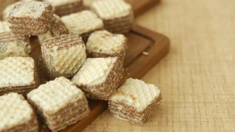 close up of chocolate wafers on a wooden board