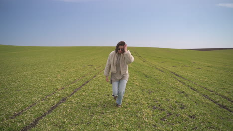 A-Young-Beautiful-Brunette-Girl-Runs-Through-A-Green-Meadow