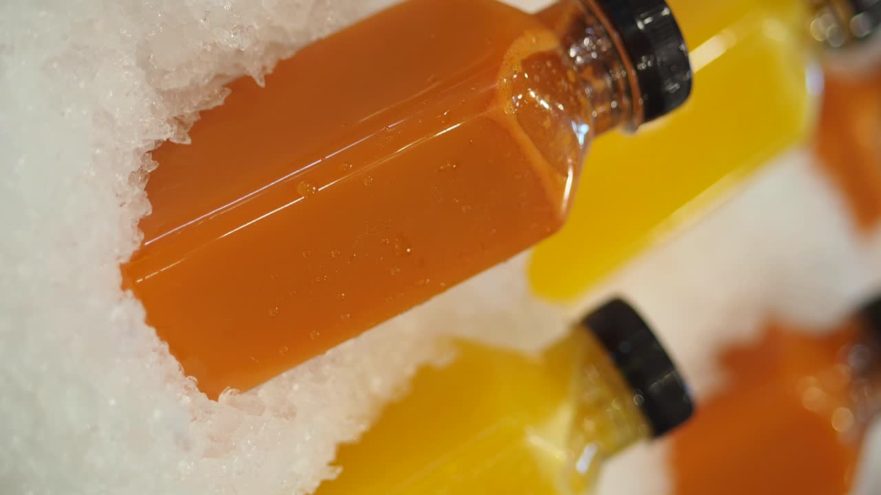 Bottles of Orange Juice on Ice