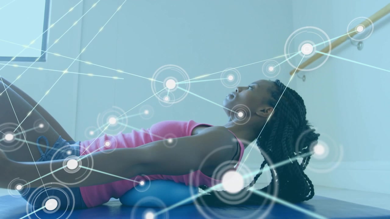 Animation of network of connections over african american woman stretching