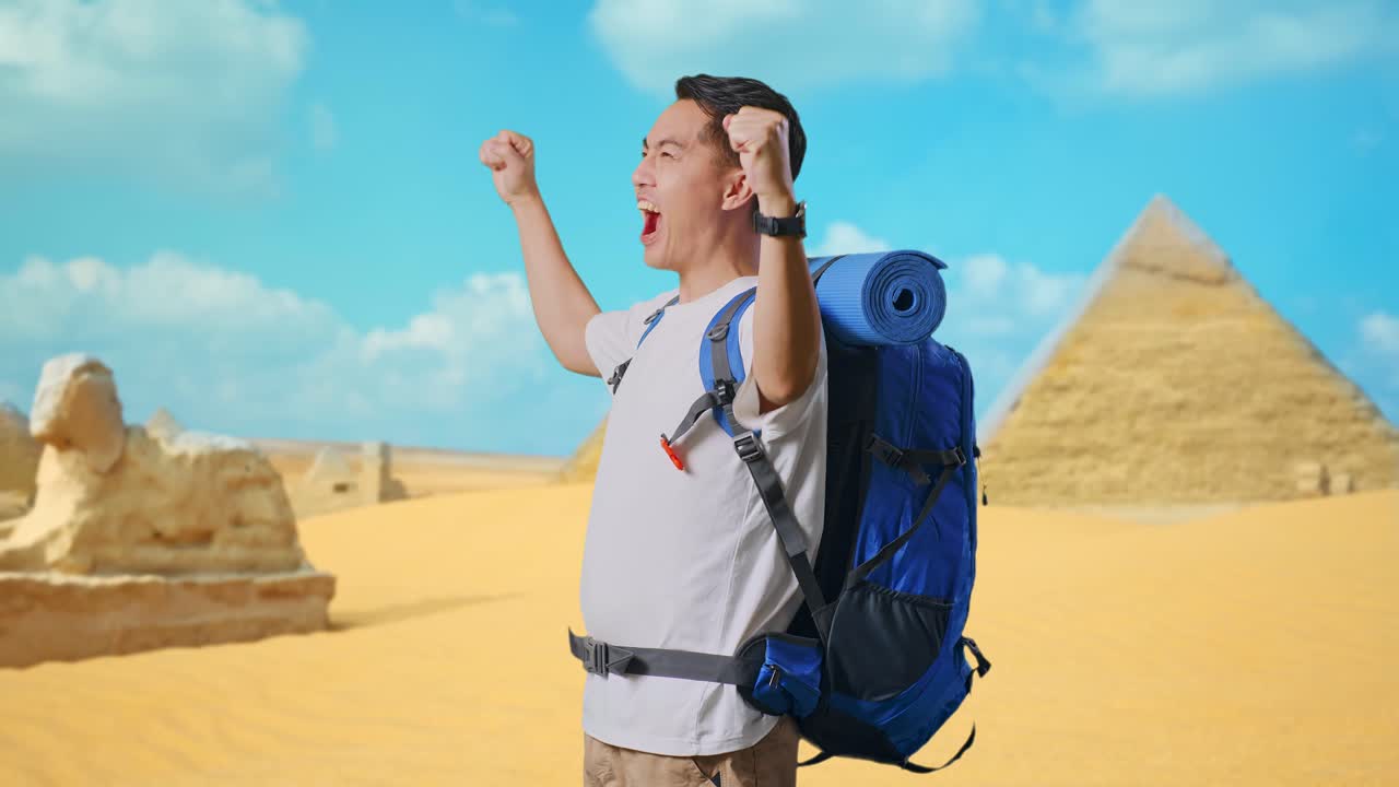 Side View Of Asian Male Hiker With Mountaineering Backpack Screaming Goal Celebrating The Success While Traveling In Pyramid Of Giza