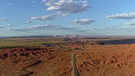 road winding through a vast red rock desert landscape