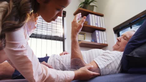 physiotherapist measuring patient hand with medical ruler 4k