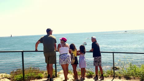 family admiring the ocean view from a coastal overlook