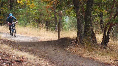 Slow-motion-mountain-bike-rider-hitting-a-small-jump