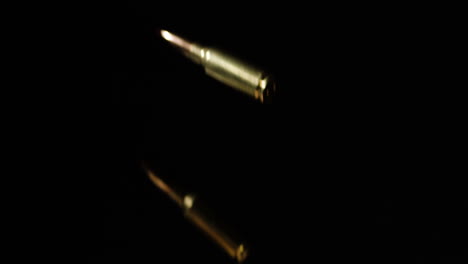 slow motion of a falling 6mm arc medium-power cartridges fall in black backdrop