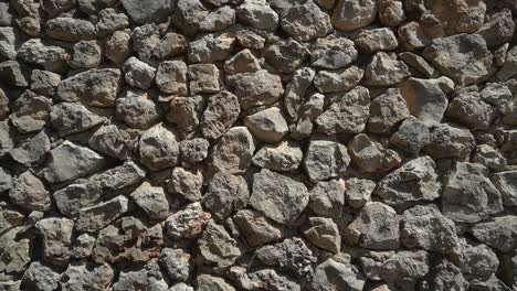 left pan - crude, unworked rock wall with visible concrete among the stones