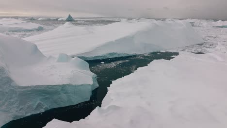 drone over sea and ice of ilulissat icefjord