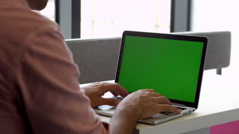 View-From-Behind-Of-Male-Student-Using-Laptop-Shot-On-R3D