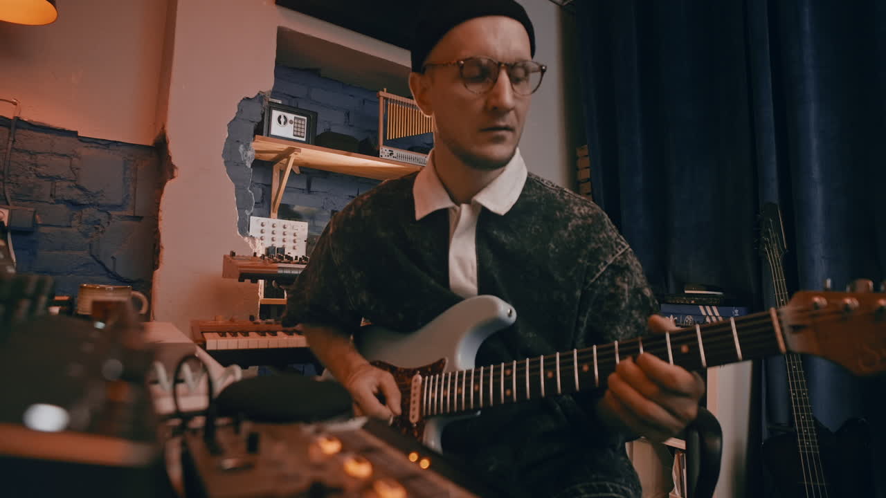 Musician Playing Electric Guitar in a Recording Studio