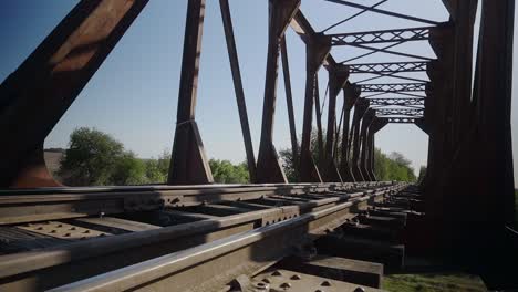 low-angle, wide view of a railway bridge in a rural area