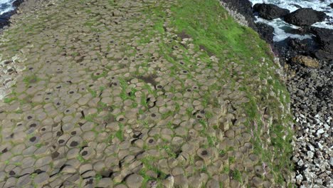 The-Giants-Causeway-lies-at-the-foot-of-the-basalt-cliffs-along-the-sea-coast-on-the-north-shores-of-County-Antrim