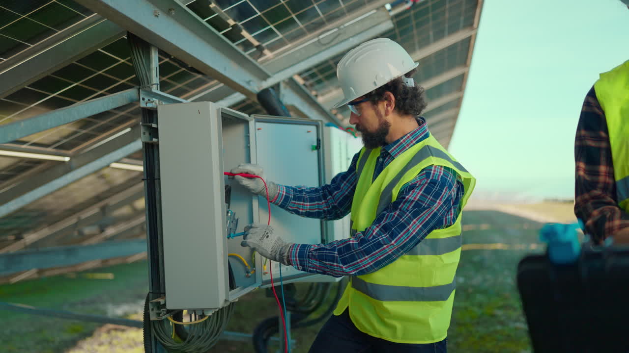 Technician inspecting solar panel installation