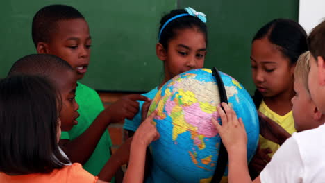 pupils looking at the globe in classroom