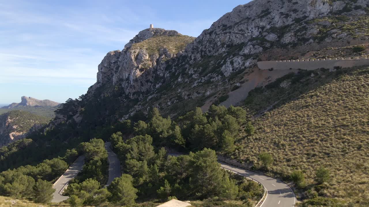 Experience breathtaking views of Pollensa's stunning landscape as you approach Mirador es Colomer. The clear skies and rugged terrain showcase the natural beauty of Mallorca's coastline.