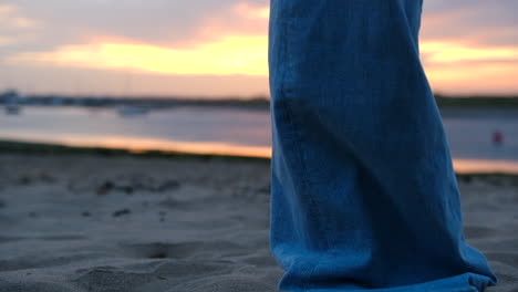 Woman-walking-towards-camera-in-the-sand-in-bare-feet