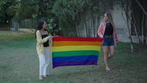 two women holding a pride flag