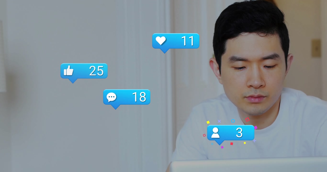 Vertical video: Man on laptop viewing likes sparking moving bubbles and counts rising for marketing