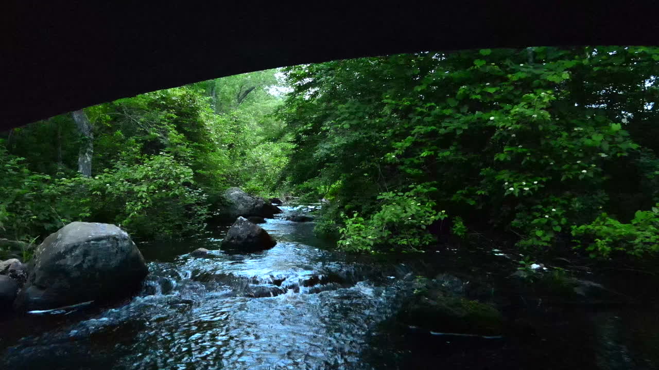 Flying Under The Stone Bridge Over The Eightmile River To The Forest In Devils Hopyard State Park In Connecticut, USA. - aerial