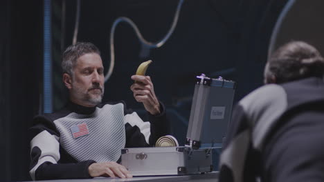 astronauts sharing food in zero gravity