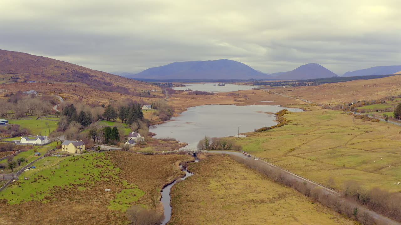 Bird's eye view of Connemara landscape. Drone descends approaching the Quiet Man Bridge.