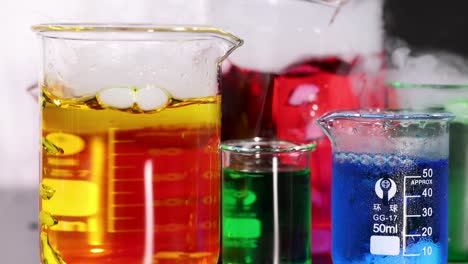 beakers with colorful liquids and dry ice reaction